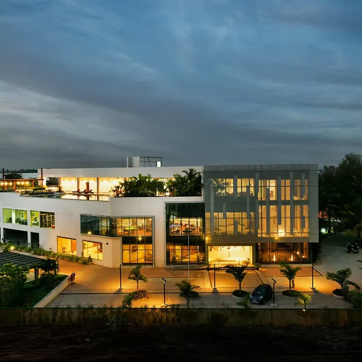 Tata New Haven, Bengaluru - another Tata Housing project Two-storey clubhouse lit at dusk at Tata New Haven, Bengaluru
