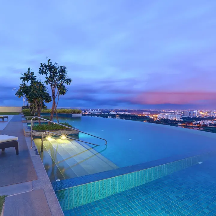 The Promont, Bengaluru - another Tata Housing project Infinity-edge pool at dusk overlooking the city at The Promont, Bengaluru